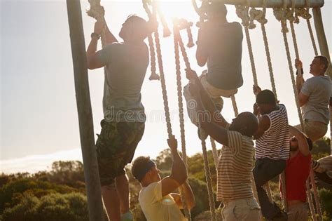 Dont Stop Till You Reach The Top A Group Of Men Climbing Up Ropes At A