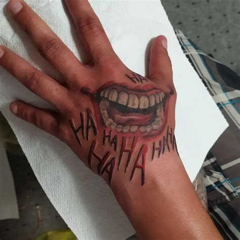 Joker Smile Hand Tattoo Designs