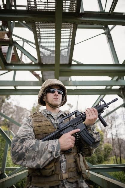 Premium Photo Military Soldier Guarding With A Rifle In Boot Camp