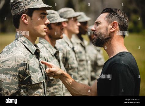 Trainer Giving Training To Military Soldiers At Boot Camp Stock Photo